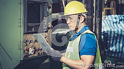 Smart factory worker using machine in factory workshop Stock Photo