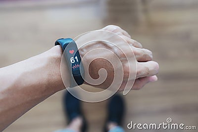 Smart fitness tracking and watch. a man using smart band tracking heart rate and health data Stock Photo