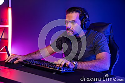 Gaming streamer concentrating gaming players trying to pass level. Surmise. Stock Photo