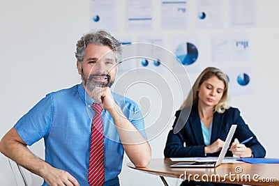 Smart german businessman with grey hair and computer Stock Photo