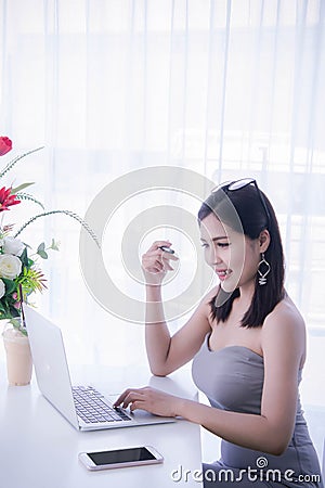 Smart girl`s working on notebook , Workingwoman using laptop in the room Stock Photo