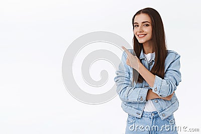 Smart good-looking, creative young brunette girl giving advice, pointing upper left corner, suggest promo, smiling Stock Photo