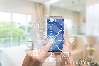 Smart home automation app on mobile with home interior in background. Internet of things concept at home. Smart technology 4.0 Stock Photo