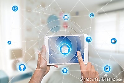 Smart home automation app on tablet with home interior in backgr Stock Photo