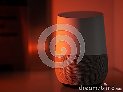Smart home speaker assistant device in moody coloured LED lighting - Orange Stock Photo