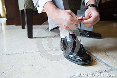 Smart man fastening shoelace Stock Photo