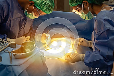 Smart medical technology in hospital concept, doctor in Surgeons team field holding medical instruments for surgery the patient in Stock Photo