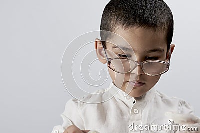 A smart mixed raced boy wearing glasses Stock Photo