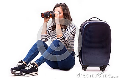 Smart nice girl look over Binoculars, sitting with her big luggage Stock Photo