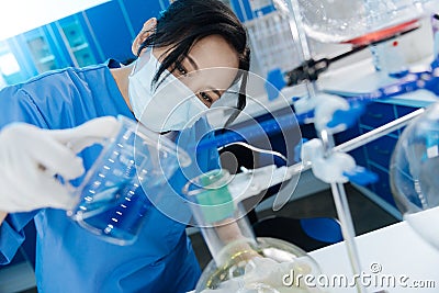 Smart nice woman being interested in chemistry Stock Photo