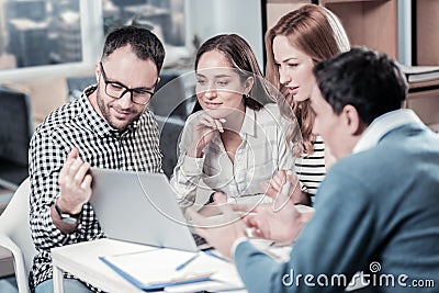 Smart occupied workers using the laptop and looking at screen. Stock Photo