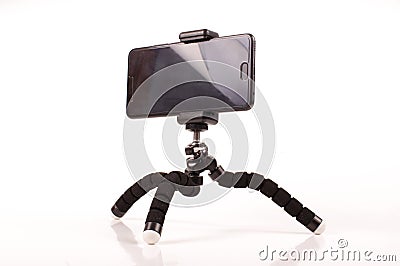 Smart phone with flexible tripod on the white background Stock Photo