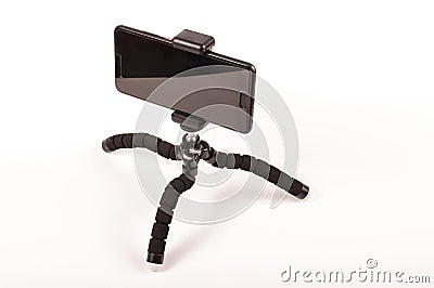 Smart phone with flexible tripod isolated on the white background Stock Photo