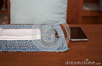 Smart phone on food table and napper and fork for social network addiction as meal concept Stock Photo