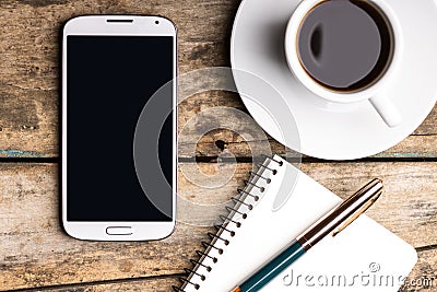 Smart phone with notebook and cup of strong coffee Stock Photo