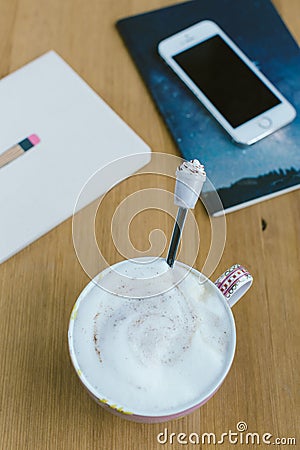 Smart phone with notebook and cup of strong coffee on wooden background. Stock Photo