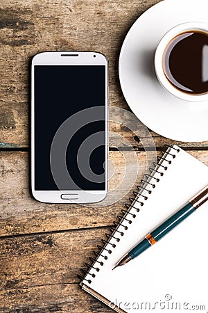 Smart phone with notebook and cup of strong coffee Stock Photo