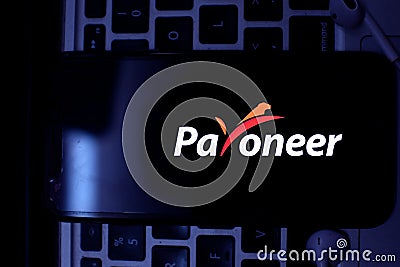 Smart phone with the Payoneer logo is a financial Editorial Stock Photo