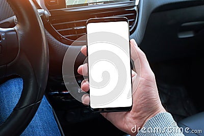 Smart phone with screen for mockup in car driver hand. Close up Stock Photo