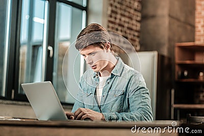 Smart pleasant man looking at the laptop screen Stock Photo