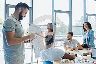 Smart positive man noting down information Stock Photo