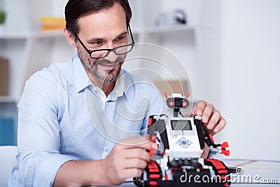 Smart scientist working on a robot production Stock Photo