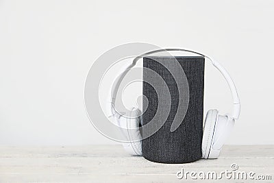 Smart speaker Amazon Alexa Echo device next to some books and hearphones against a white background. Empty copy space Stock Photo