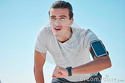 Smart watch, outdoor fitness and man tired from exercise workout, training and run. Stopwatch time, sports person and Stock Photo