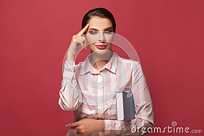 Smart woman thinking and holding book, idea concept Stock Photo