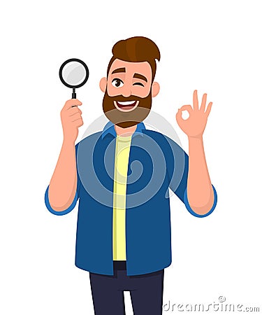 Smart young man holding magnifying glass and gesturing okay/OK sign while winking eye. Deal, good, agree, search, find, discovery. Vector Illustration