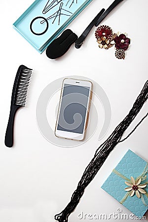 Smartphone, Accessories and hair pins flat lay. Sponge for hair, hairdo babette. necklaces of beads or flowers, tiffany blue boxes Stock Photo