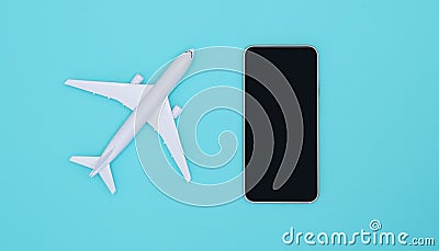 Smartphone and airplane on sky blue background. Smartphone application for online searching, buying and booking flights on the int Stock Photo