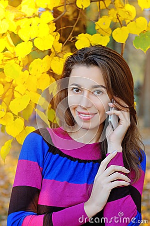 Smartphone Autumn woman talking on mobile phone in fall Stock Photo