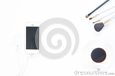 Smartphone with beauty make up brush set and coffee cup on white Stock Photo