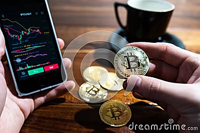 Smartphone with Bitcoin trading chart on the screen Stock Photo