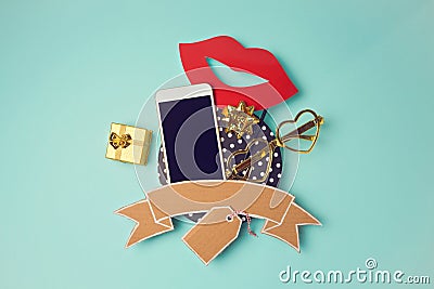 Smartphone with cardboard banner and gift box. Creative website hero image. Stock Photo