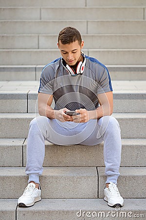 Smartphone cell phone listening to music portrait format young latin man listen Stock Photo