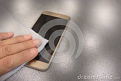 Smartphone cleaning dirty screen with blue microfiber fabric Stock Photo
