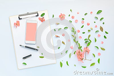 Smartphone and clipboard mock up with floral decoration flat lay Stock Photo