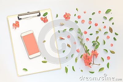 Smartphone and clipboard mock up with floral decoration flat lay Stock Photo