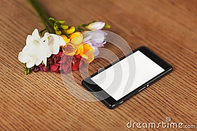 Smartphone and flowers on the table Stock Photo