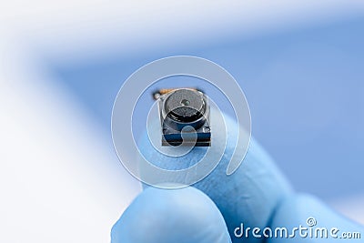 Smartphone front camera module on fingertip in laboratory Stock Photo