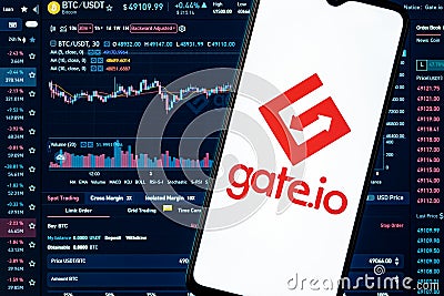 A smartphone with the Gate.io logo on the background of the live trading webpage Editorial Stock Photo