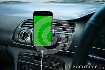 Smartphone on generic car's dashboard Stock Photo