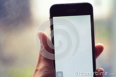 Smartphone in hand - people and technology concepts Stock Photo