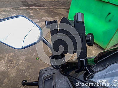 The smartphone holder is mounted on the motorcycle handlebar Stock Photo