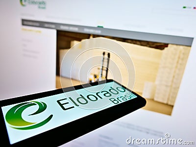 Smartphone with logo of Brazilian pulp manufacturer Eldorado Brasil Celulose SA on screen in front of website. Editorial Stock Photo