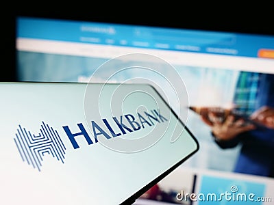 Smartphone with logo of company Turkiye Halk Bankasi AS (Halkbank) on screen in front of business website. Editorial Stock Photo