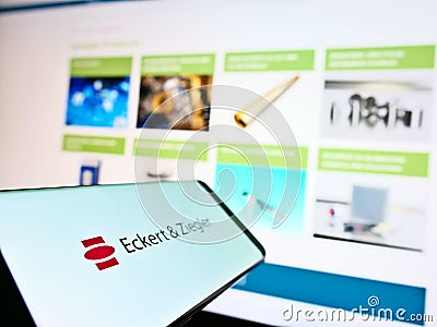 Smartphone with logo of German medical technology company Eckert und Ziegler on display with business website. Editorial Stock Photo