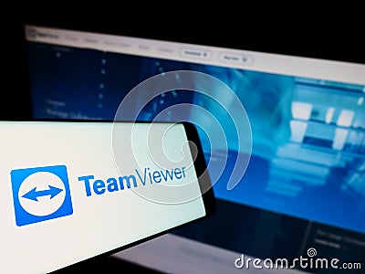 Smartphone with logo of German technology company TeamViewer AG on screen in front of business website. Editorial Stock Photo